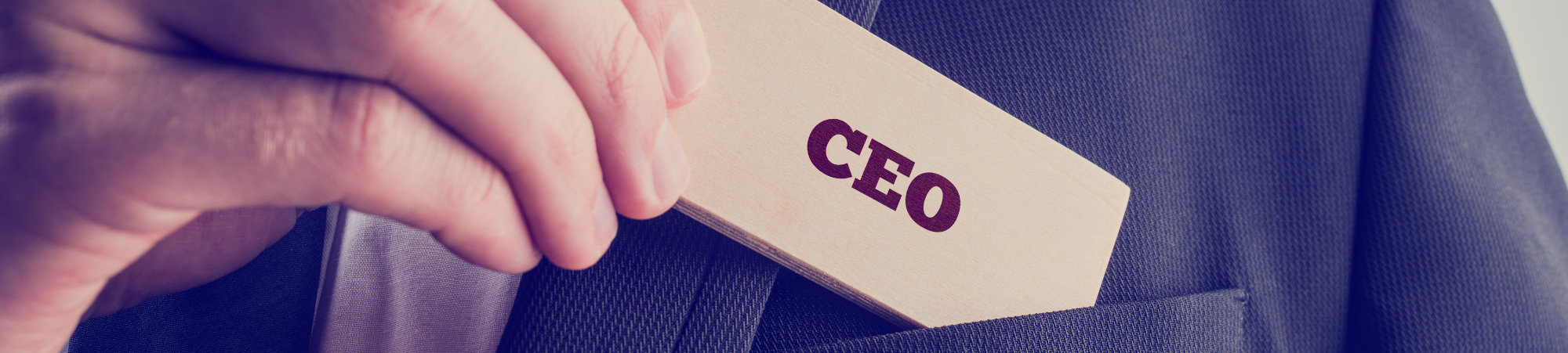 Photo of man in suit pulling out a CEO card